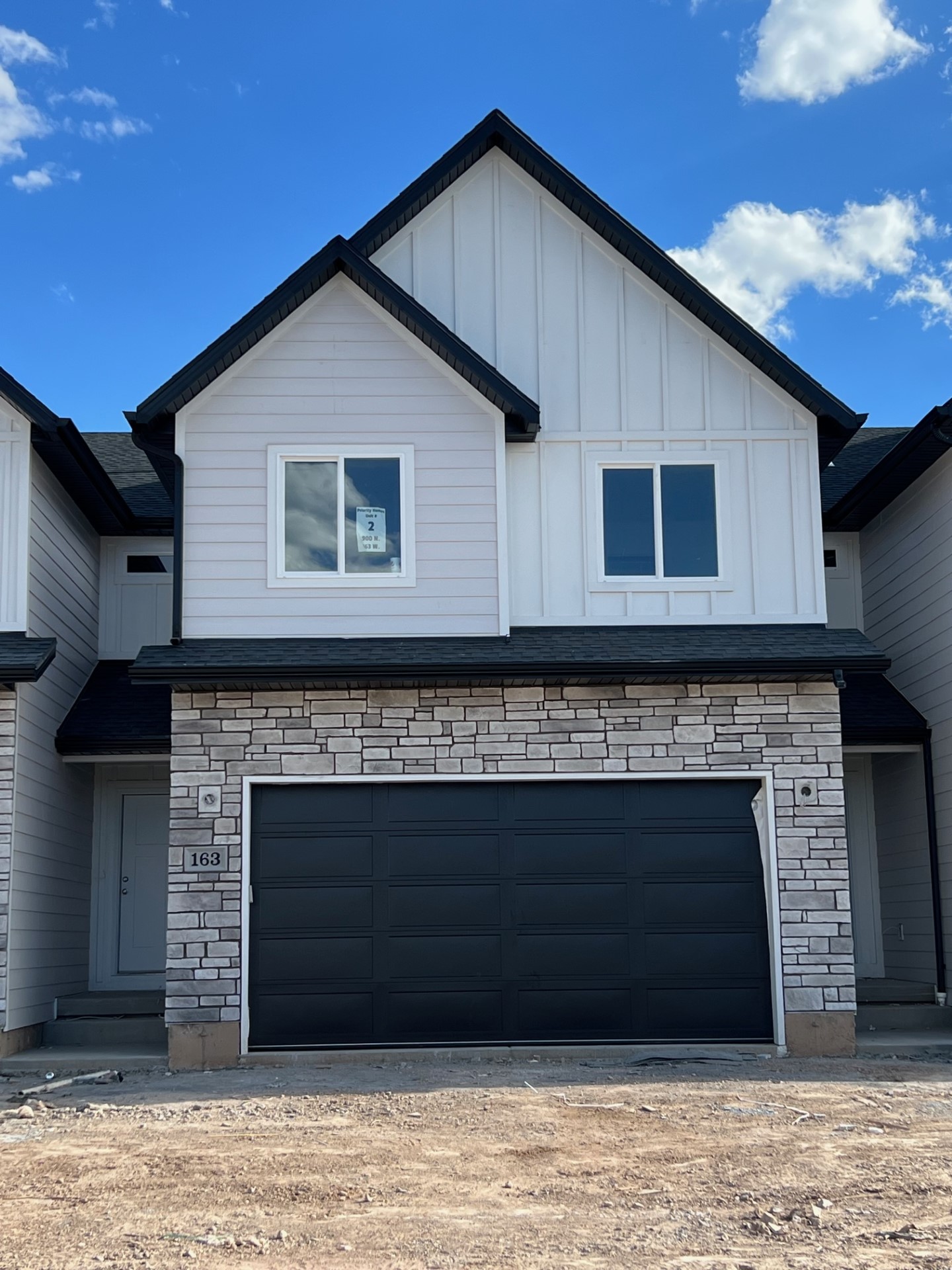 Priority Homes townhouse exterior with private entrance and attached two-car garage in Utah