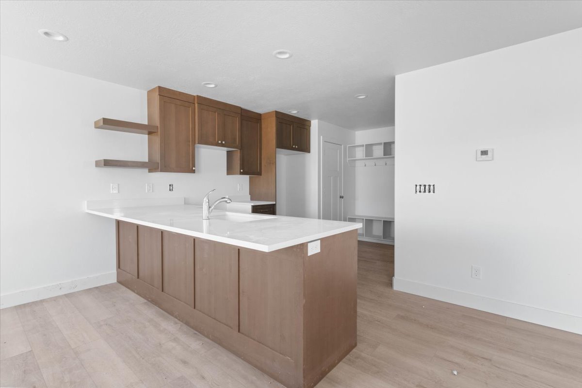Loveless Estates townhouse kitchen interior in Nephi Utah with brown cabinetry and modern finishes