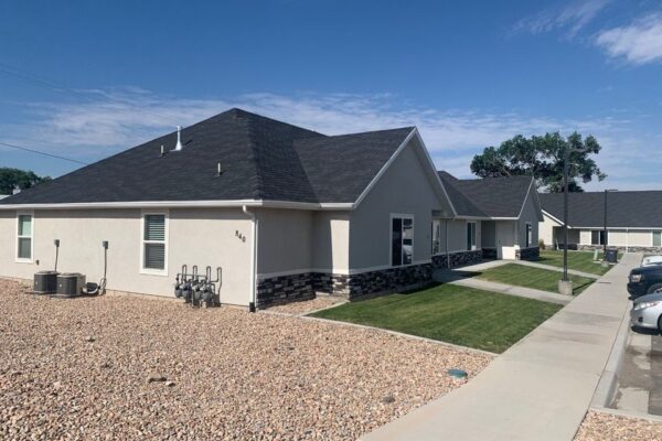 Newly constructed apartment buildings at Ray’s Apartments in Nephi, featuring modern design, well-maintained landscaping, and convenient access to parking.